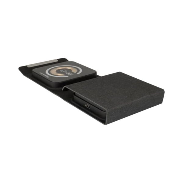 A sleek, black wireless charging pad with an integrated design. It features two distinct sections: one for charging a device and a textured compartment for cable storage. The charging pad has a circular symbol indicating wireless charging capabilities.