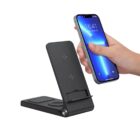 A hand holding a smartphone above a black multi-device wireless charging stand with separate charging areas for a phone and smartwatch. The phone screen displays the time 16:41 and the date January 22.