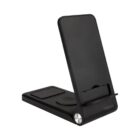 A black multi-device charging stand featuring a phone holder, a wireless charging pad, and a watch charger. The stand is angled to display devices, with a sleek design and a metallic accent at the base.