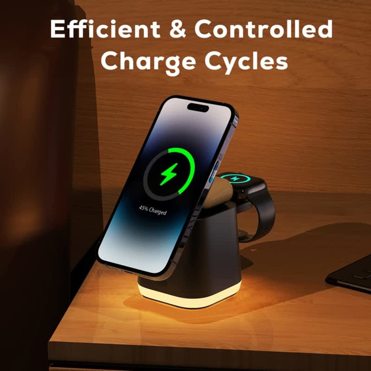 A smartphone and smartwatch charging on a wireless charging stand, displaying charging indicators. Text above reads, Efficient & Controlled Charge Cycles. The setup is placed on a wooden surface.
