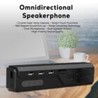 A black omnidirectional speakerphone with multiple ports and buttons sits on a wooden table near a potted plant and a white cup. Text above lists features: voice capture, touch functions, 360-degree sound, noise cancelling, dual mics, and speakers.