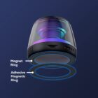 Transparent smart speaker with magnet and adhesive magnetic ring on a dark blue background.