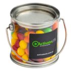 Small clear bucket filled with colorful candy, featuring an ActivateUTS logo on the side.