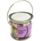 A clear paint can filled with assorted candies and a purple label on the front.