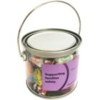 A small paint can filled with assorted candies and a label reading Supporting families safety.