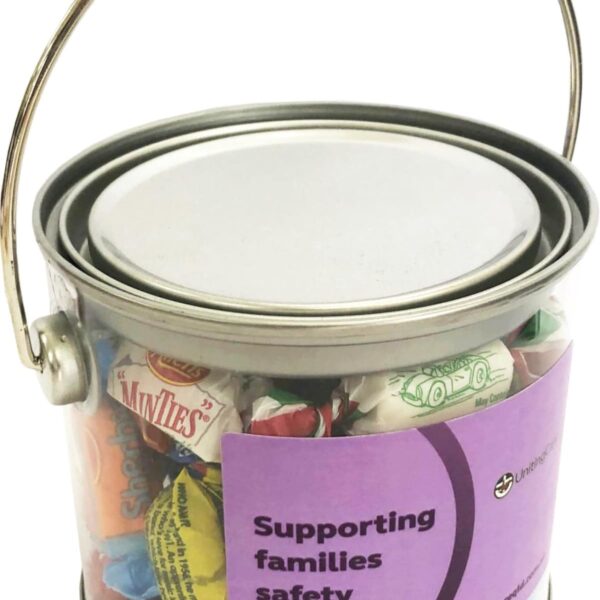 Clear bucket with assorted candies and a label that reads Supporting families safety.