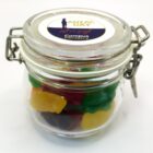 Glass jar with colorful gummy bears and an Anzac Day Lest we forget label on the lid.