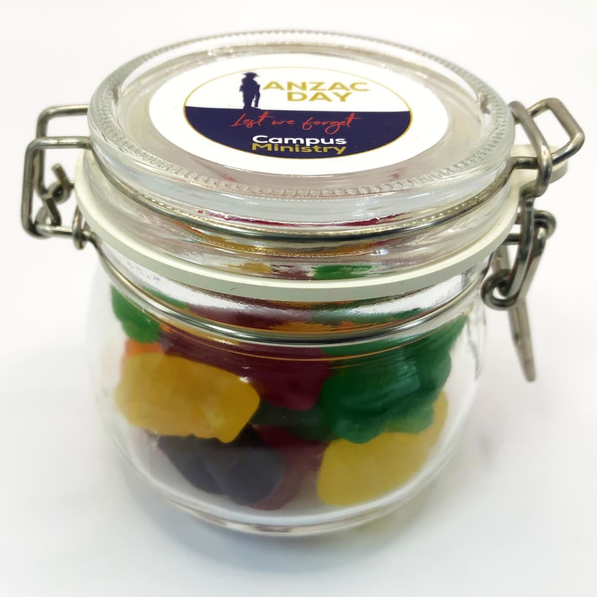 Clear jar with colorful gummy bears and an ANZAC Day label on the lid.