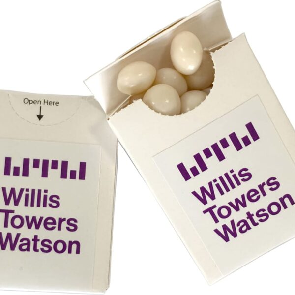 Two white boxes labeled Willis Towers Watson with white candies inside one box.