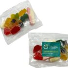 Two clear bags of assorted gummy candies, one with a green informational sticker attached.