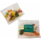 Two clear bags of assorted gummy candies, one with a green promotional sticker.