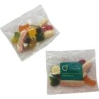Two clear bags of assorted gummy candies, one with a green and blue label.