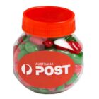 Clear jar with red lid, filled with red, green, and white candies labeled Australia Post.