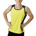 Young man in a yellow athletic tank top and black pants standing with hands on hips.