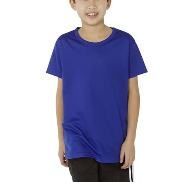 A smiling boy wearing a blue T-shirt and black shorts with white stripes stands against a plain white background. He has short hair and is looking directly at the camera.