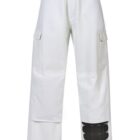 White cargo pants with side pockets and a black knee pad on the right leg.