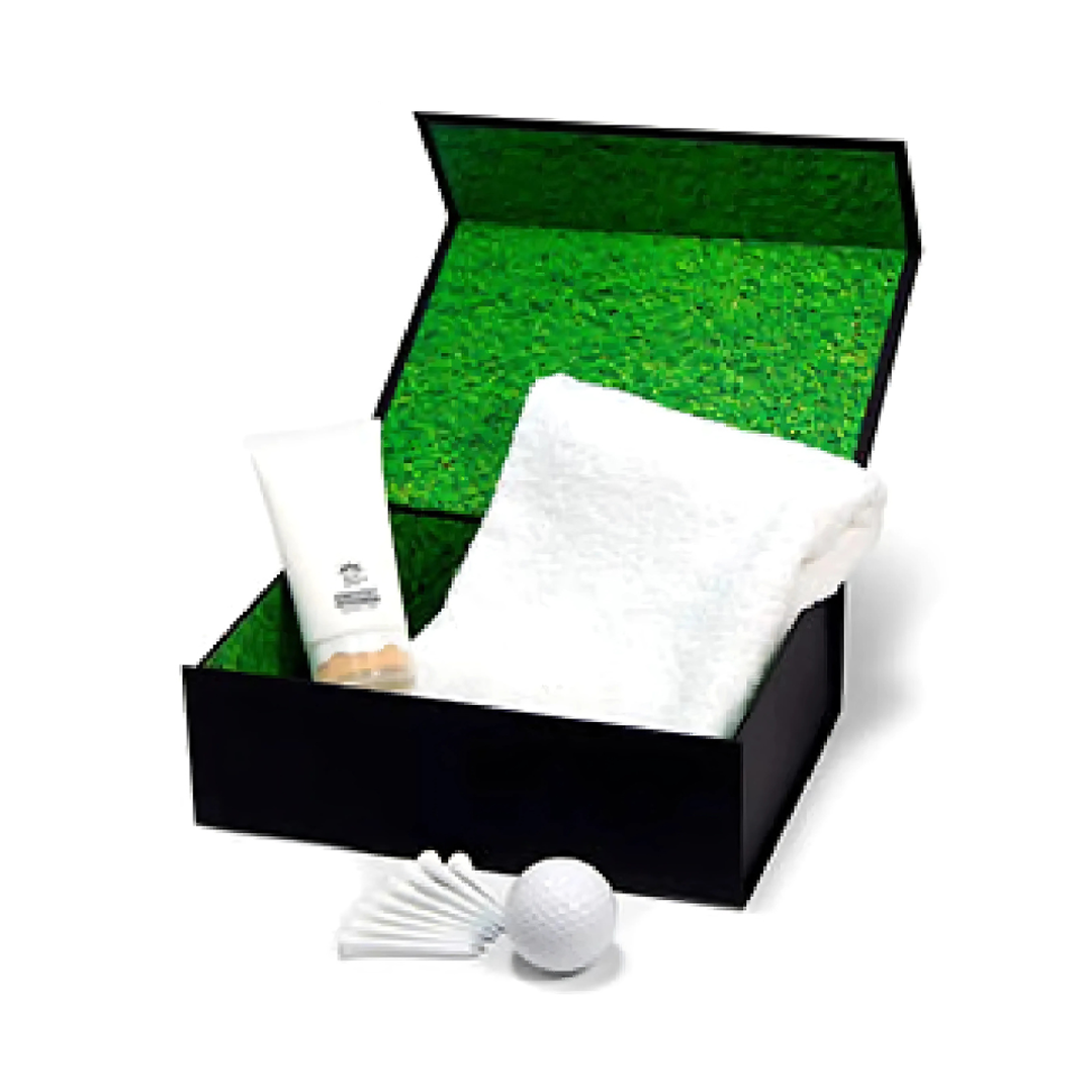 Open gift box with a towel, lotion, and Aussie Summer Custom Golf Set on green backdrop.