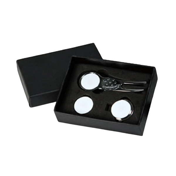 The Professional Clip and Marker Gift Box contains a metal keychain with a retractable feature, two round white discs, and a sleek marker. Its black gift box has a lid slightly angled left, showcasing the neatly arranged items against the black background.