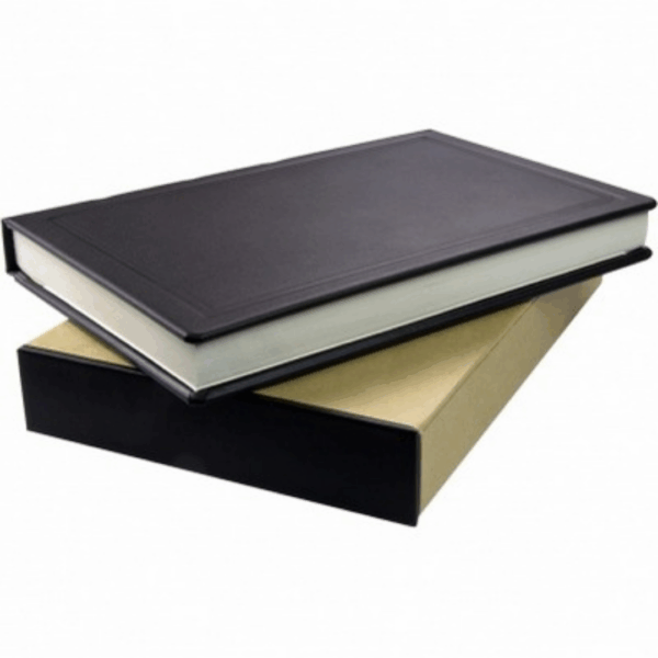 A closed Yarmouth Deluxe Leather Journal resting on a tan and black box.