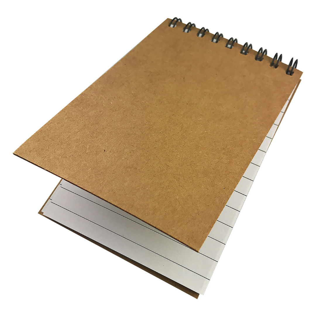 A small, brown Basic Spiral Notepad with lined pages is partially open.