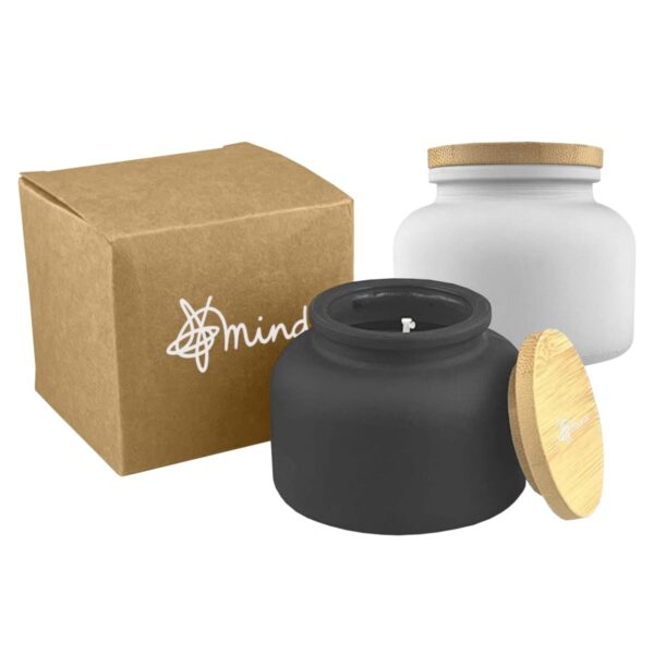 Brown box with logo, black candle jar with wooden lid, and white jar with wooden lid.