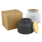 Black and white glass jars with wooden lids and a brown cardboard box.