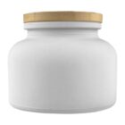 White glass jar with a wide body and a flat, textured wooden lid, against a white background.