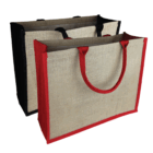 Set of 2 Kala Jute coloured bags, each with red or black handles and trim.