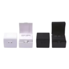 Four Cube Travel Adapter & USB Ports—two black, two white—shown with lids open and closed.