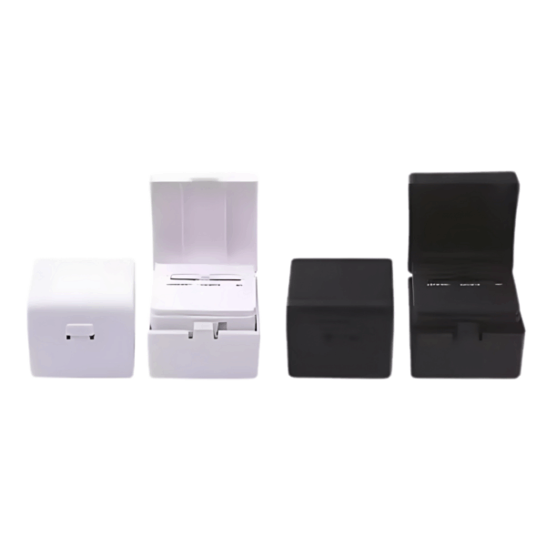 Four Cube Travel Adapter & USB Ports—two black, two white—shown with lids open and closed.