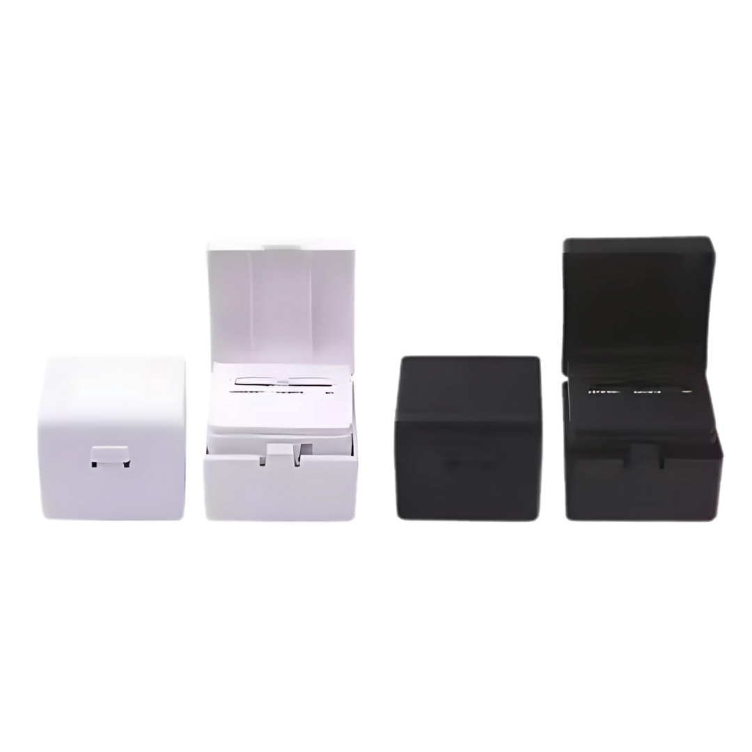 Four Cube Travel Adapter & USB Ports—two black, two white—shown with lids open and closed.