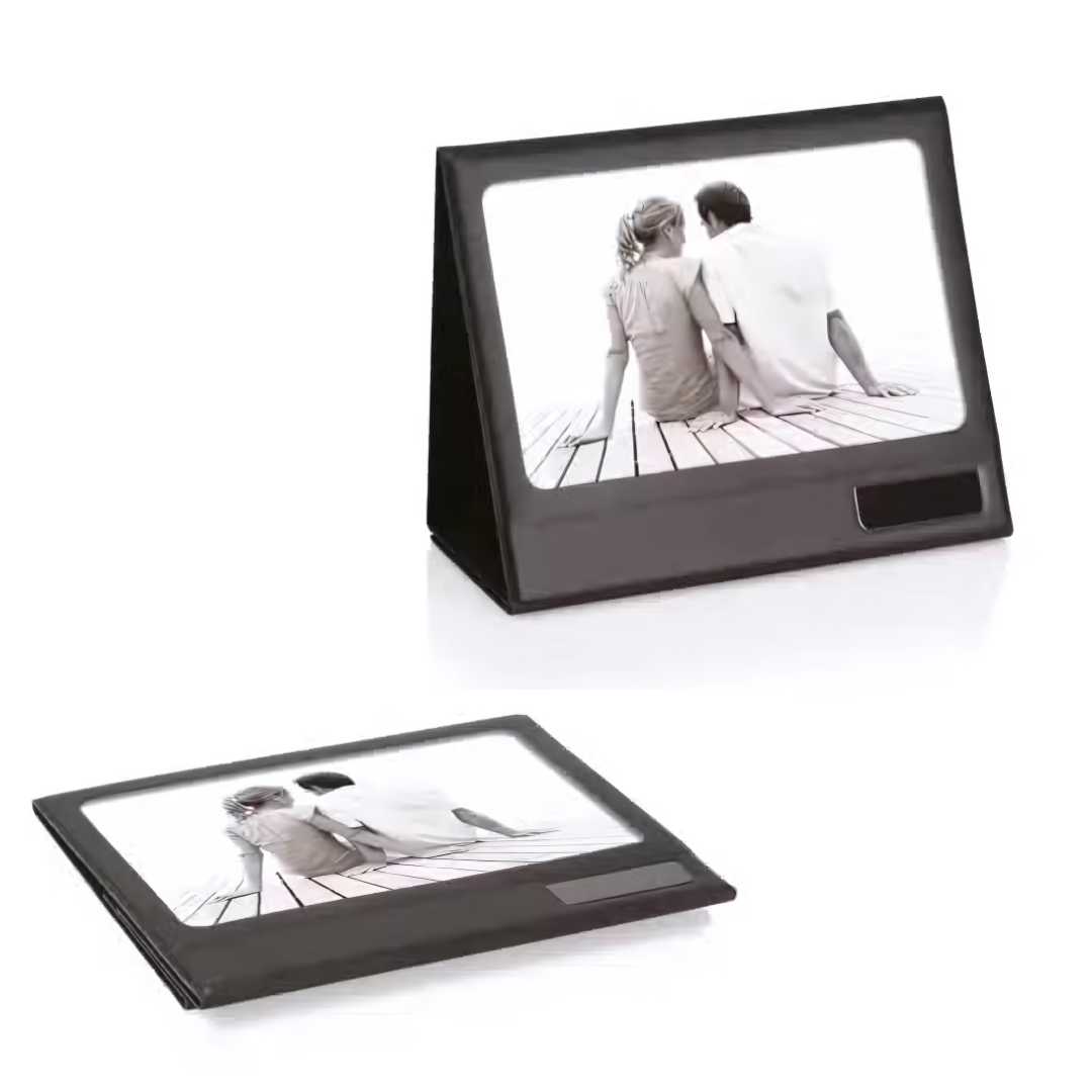 Two people sit on a dock in the Fold up Desk Photo Frame, displayed upright on a desk.