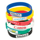 Stack of six Dome Printed Silicone Bands featuring assorted company logos.
