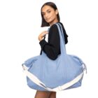 Woman in black hoodie carrying a large light blue duffel bag with white straps.
