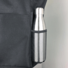 A silver bottle in the black mesh pocket of a Best Selling Nylon Shopping Tote.