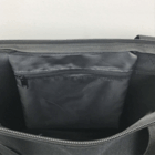 Best Selling Nylon Shopping Tote, black, open with zippered pocket on light background.