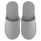 A pair of simple gray slippers seen from above on a white background.