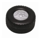 A round, black tire-shaped object with a silver, star-like hubcap design in the center. The tire has a textured tread pattern around its circumference.