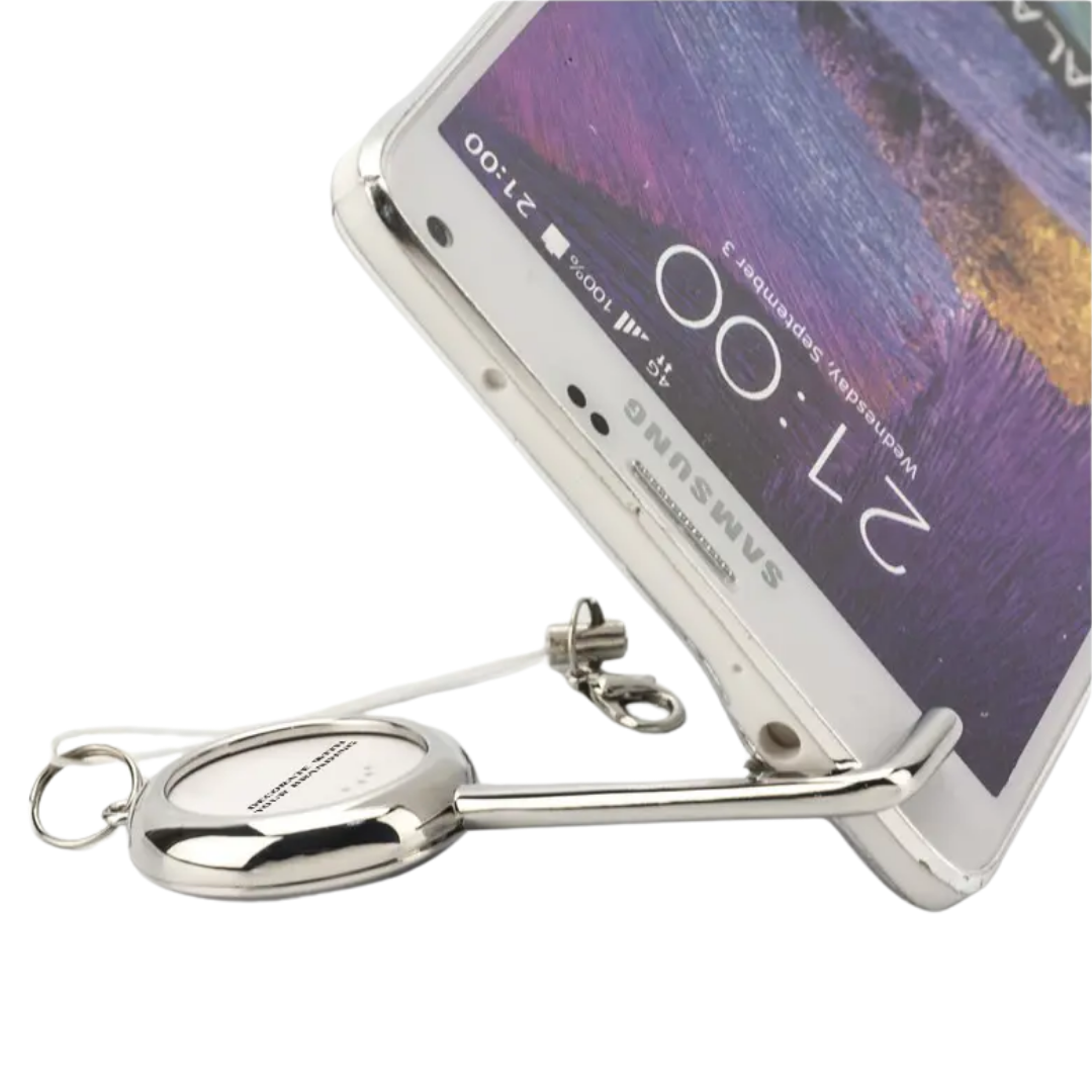 A smartphone rests on a Customised Tracker Key Finder Smartphone Stand shaped like a key.