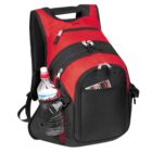 A red and black backpack with multiple compartments and zippers. A water bottle is in the mesh side pocket, and a magazine sticks out of the front pocket. The backpack has a handle on top and adjustable shoulder straps.