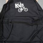 Black backpack with Platinum Kids and a bicycle graphic printed in white on the front.