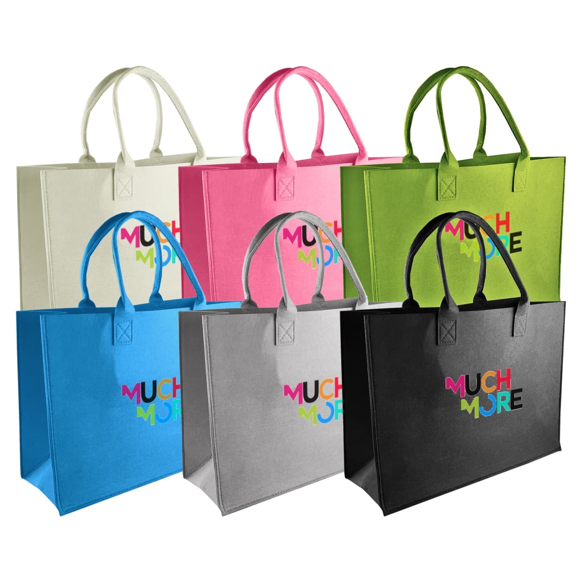 Six colorful tote bags are displayed in two rows. They come in white, pink, lime green, blue, gray, and black. Each bag has two handles and the words Much More printed in a multicolored font on the front.