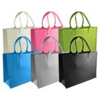 Six reusable tote bags in assorted colors: white, pink, green, blue, gray, and black, arranged in two rows. Each bag features handles and a rectangular shape, suitable for shopping or carrying items.