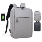 A sleek, modern gray backpack with a USB charging port and a phone connected, displayed alongside two smaller images showing the backpack in gray and black variations. It features a front pocket and padded shoulder straps.
