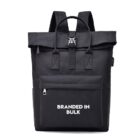 Black backpack with front pocket and BRANDED IN BULK text printed in white on the pocket.