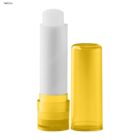 Yellow and white lip balm tube with the cap off.