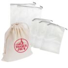 A Trader Joes cloth bag and four clear reusable produce bags with drawstrings.