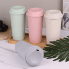 Four pastel Phoenix Reusable Eco Coffee Cups with lids, one cup lying down in front.