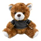 Brown teddy bear wearing a black shirt, sitting against a white background.