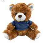 Brown teddy bear wearing a navy blue T-shirt, sitting upright against a white background.